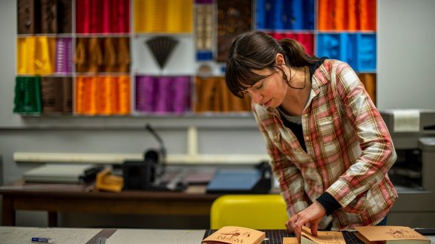 Student working in Book Arts studio. Link to Creative Arts Programs