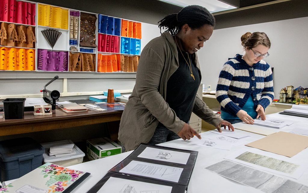 Two students work in the book arts studio