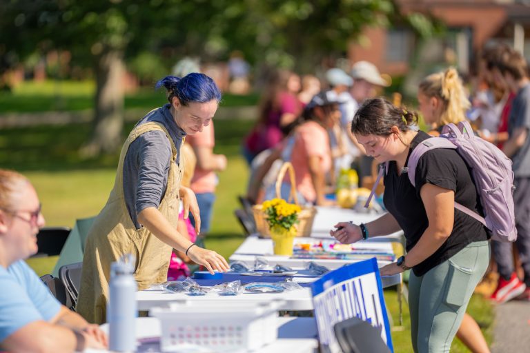 Many students outside at tables for the annual club and organizations fair