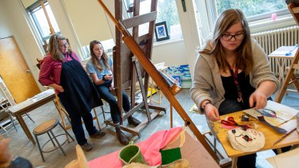 Students sitting at easels in the painting studio