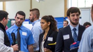 multiple students gather for conversation at a job fair