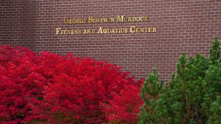 Brick wall with the sign for the Murdock Fitness and Aquatic Center