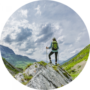 Hiker on a mountain peak. Link to Outdoor Leadership pathway.