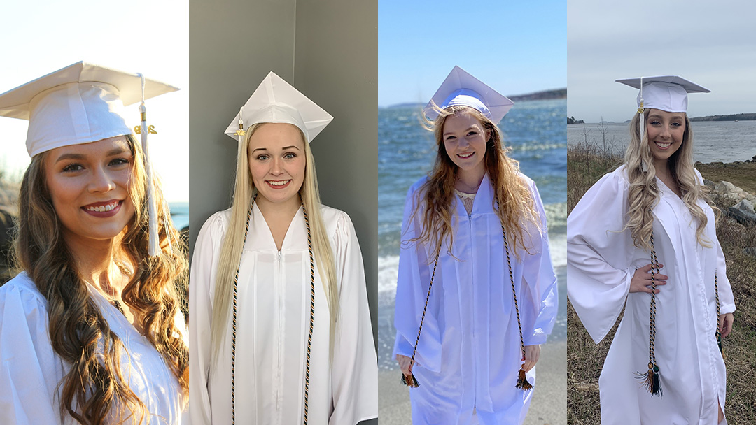 Four female students shown in their white graduation gowns