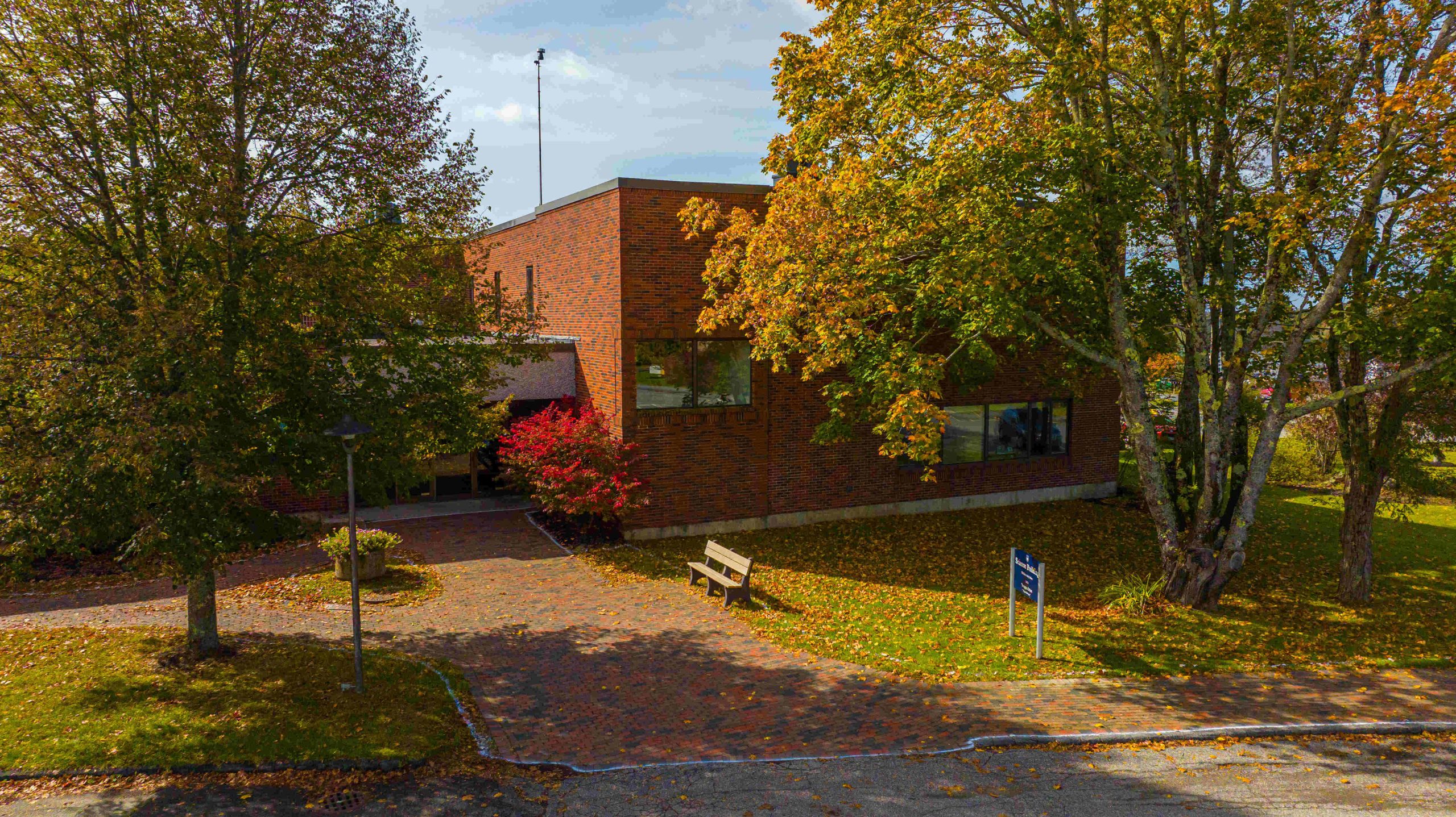 a wide shot photo of the science building on campus in fall