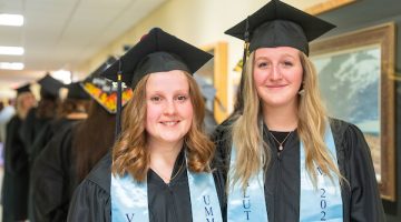 Valedictorian Katie Leighton and Salutatorian Rachel Maker stand beside each other as they prepare to line up for commencement.