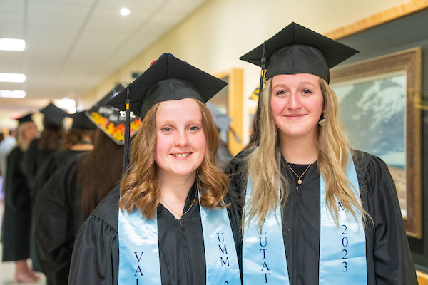 Valedictorian Katie Leighton and Salutatorian Rachel Maker stand beside each other as they prepare to line up for commencement.