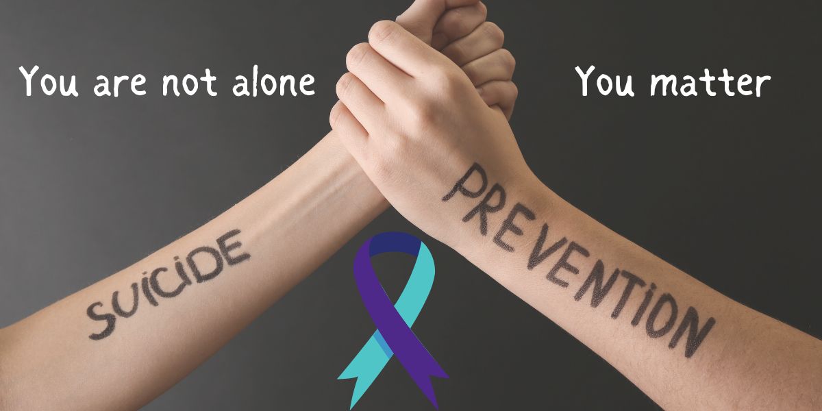 A black background with 2 clasped hands. Suicide Prevention is written on the arms. "You are not alone" and "You matter" are across the top