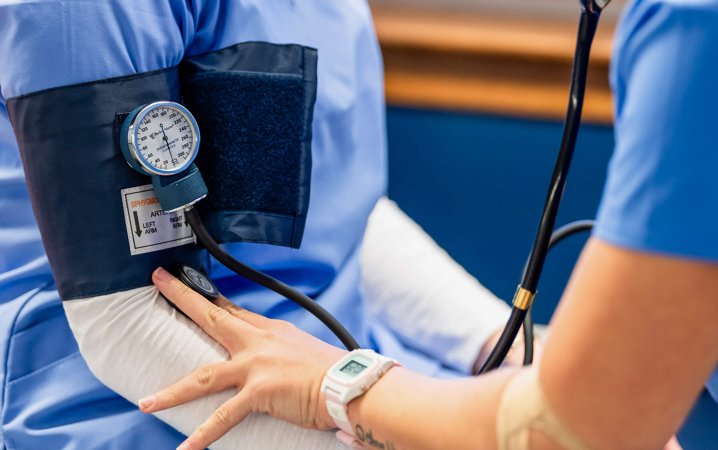 UMaine Nursing students practicing taking blood pressure