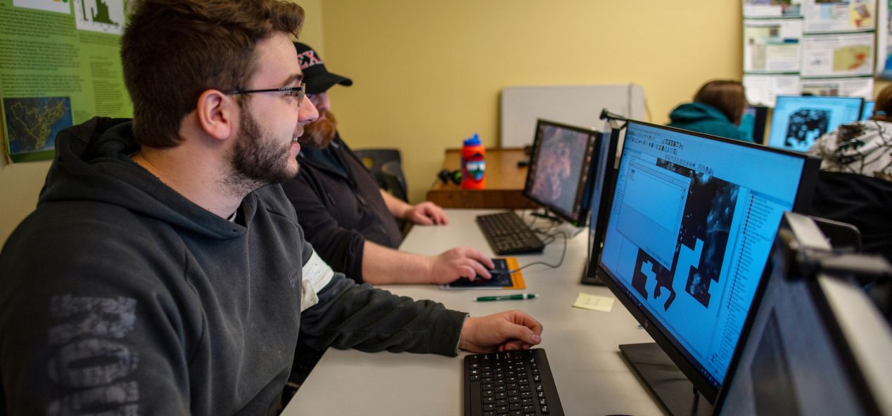 A student working on a map on a computer monitor