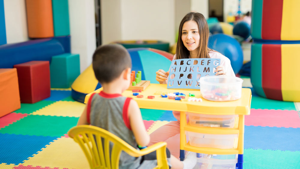 A woman and young child in a classroom