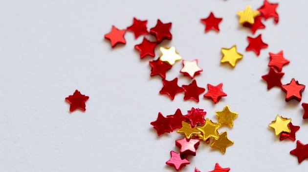 red and gold stars scattered across a white background