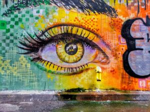 Graffiti on a wall. a giant woman's eye in several colors