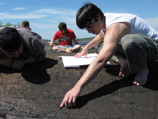 Students studying petroglyphs