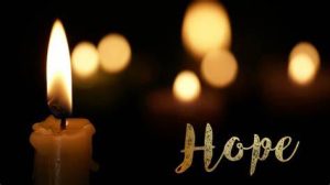 Lit candles on a black background. The word "hope" is in gold in the bottom right side