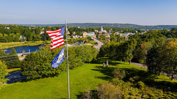 The US and State flags fly over the large front lawn on campus, overlooking down town.