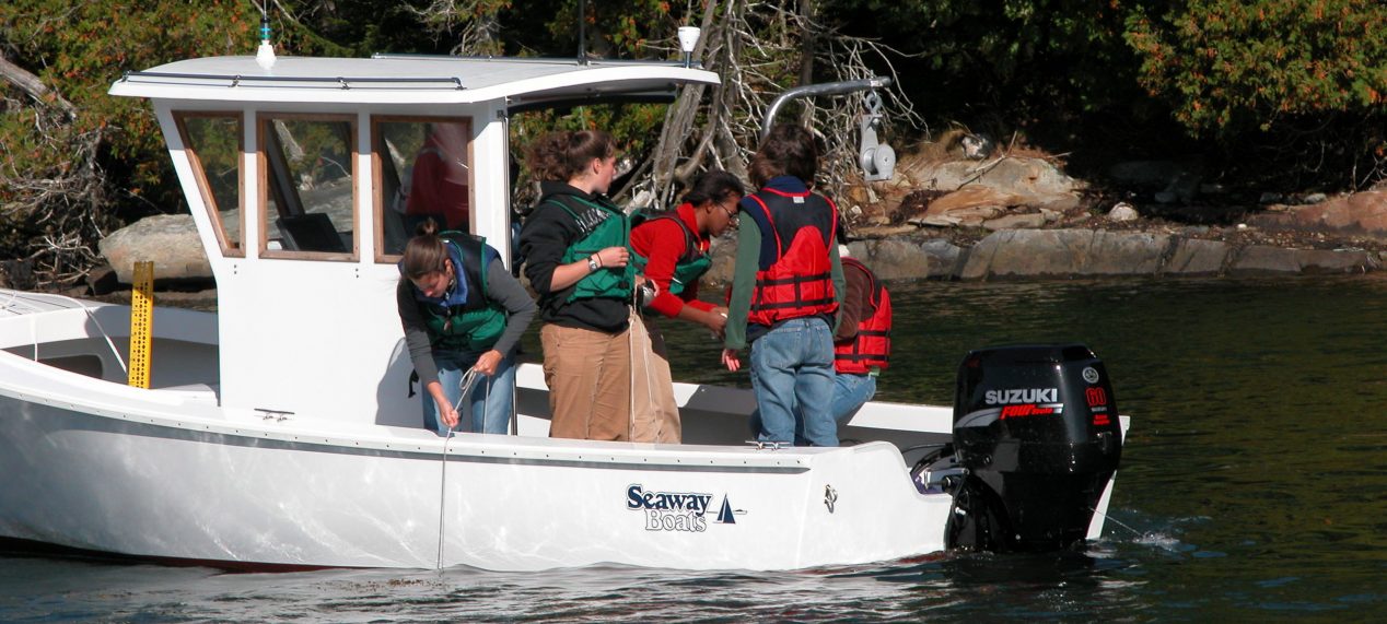 Students on a boat during a community engaged course
