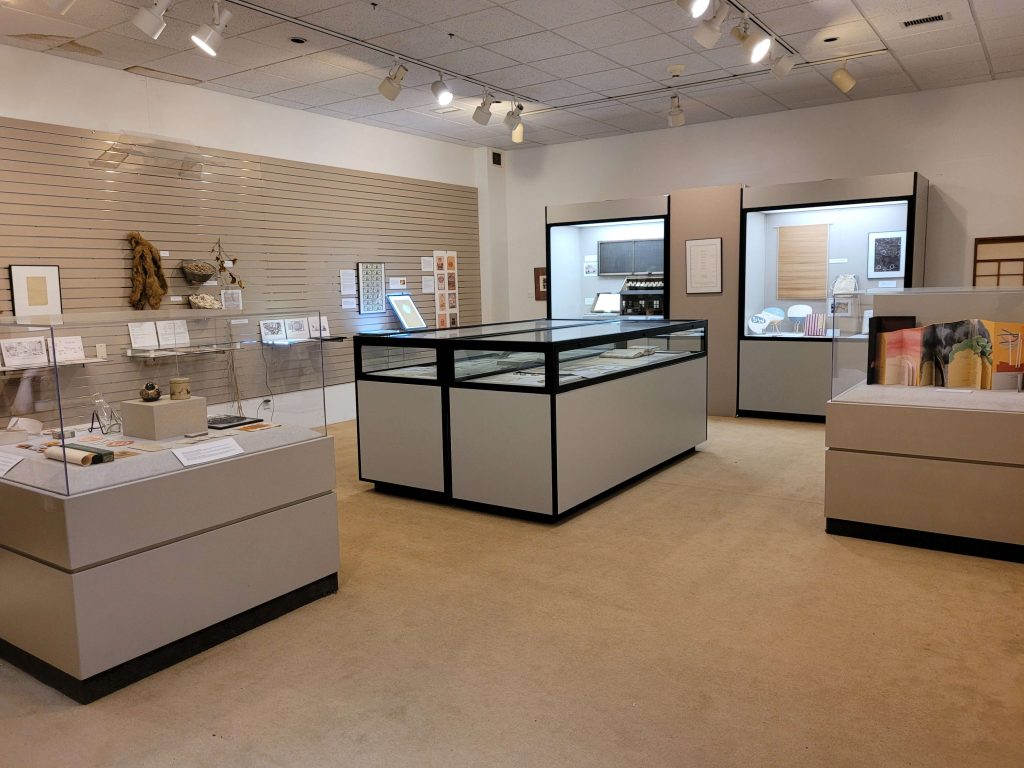 World of paper gallery display. There are items in cases and on the wall.